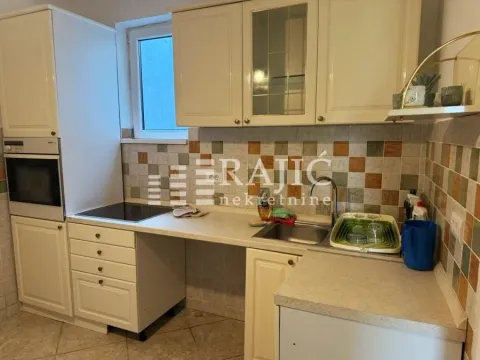 Small kitchen with light-colored cabinets and tiled walls. - image 3