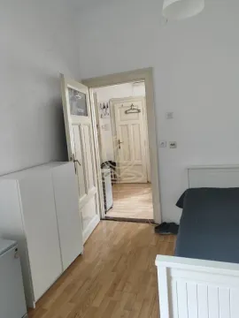 Furnished bedroom with a bed and wardrobe, overlooking the hallway. - image 5