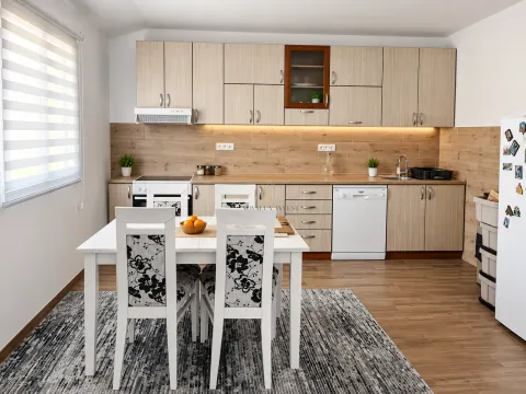 Modern kitchen with a dining area and wooden elements. - image 2