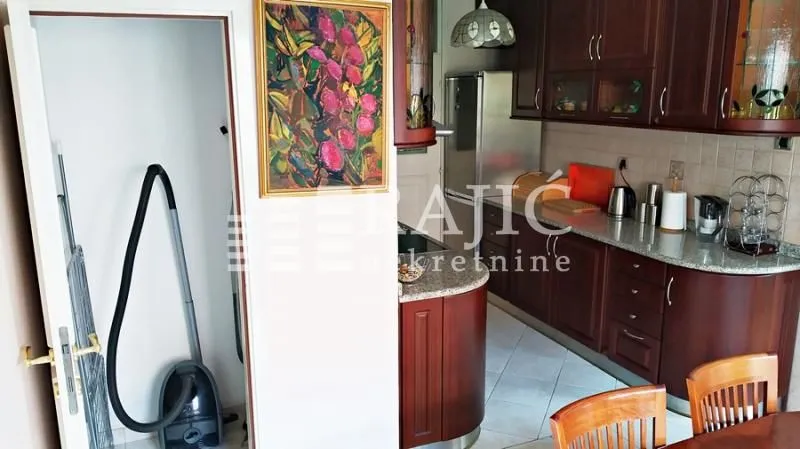 Kitchen with dark wooden cabinetry and a dining area.