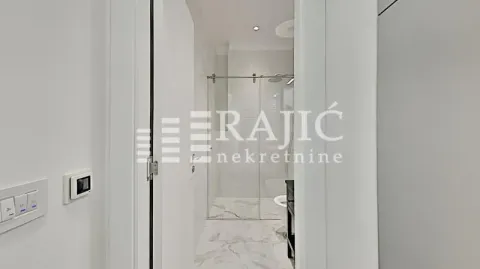 View of a modernly decorated bathroom with a walk-in shower. - image 13