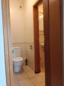 View of the bathroom with a toilet through an open door. - image 10