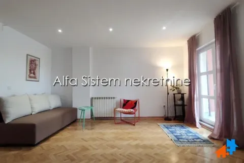 Living room with a sofa, an armchair, and parquet flooring. - image 5