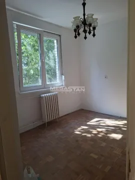 Empty room with parquet flooring, a window, and a chandelier. - image 2