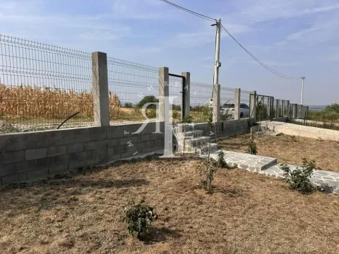 Fenced yard with a gate and paved pathways. - image 17