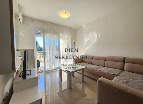 Living room with a sofa, TV, and access to the terrace. - image 9