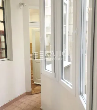 Enclosed balcony with white PVC windows and tiled floor. - image 12