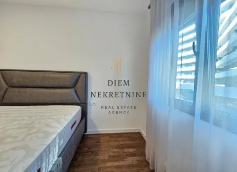 Bedroom with a double bed and a window with curtains. - image 10