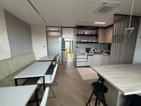 Modern kitchen with dining tables and a bench. - image 9