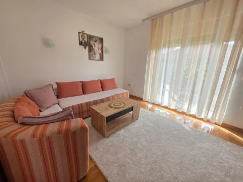 Living room with a corner sofa, coffee table, and a large window with curtains. - image 15