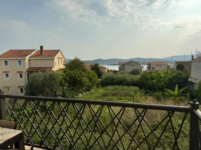 View from the terrace towards surrounding buildings and greenery.