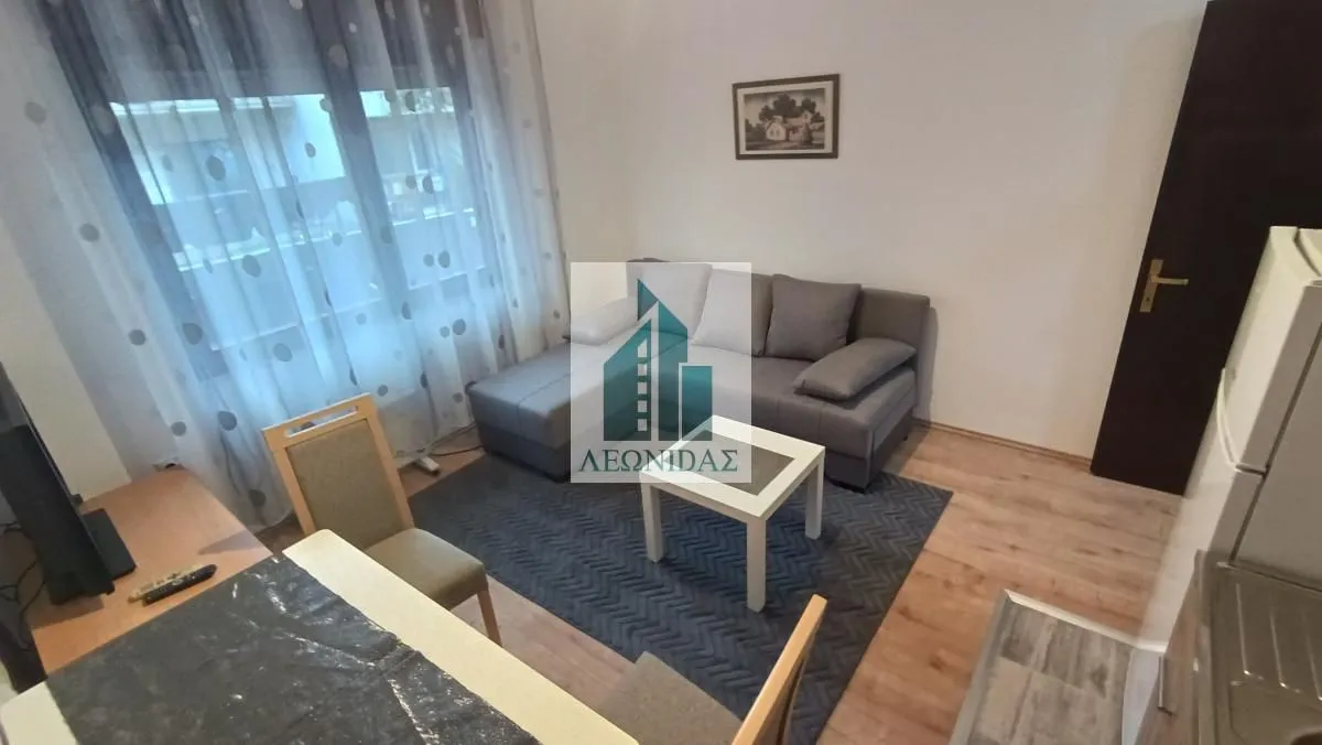 Living room with a sofa set and a dining table.