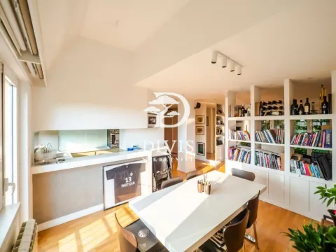 Living room with dining area and large bookshelves. - image 12