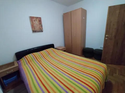 A bedroom with a double bed and a wardrobe. - image 17