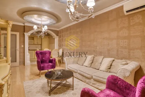 Living room with a sofa, armchairs, and a view of the dining area. - image 6
