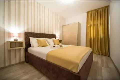 Furnished bedroom with a double bed, wardrobe, and nightstand. - image 4