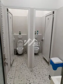 View of separate toilet cabins with white tiles. - image 10