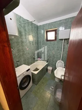 Bathroom with bathtub, toilet, bidet, and washing machine. - image 3