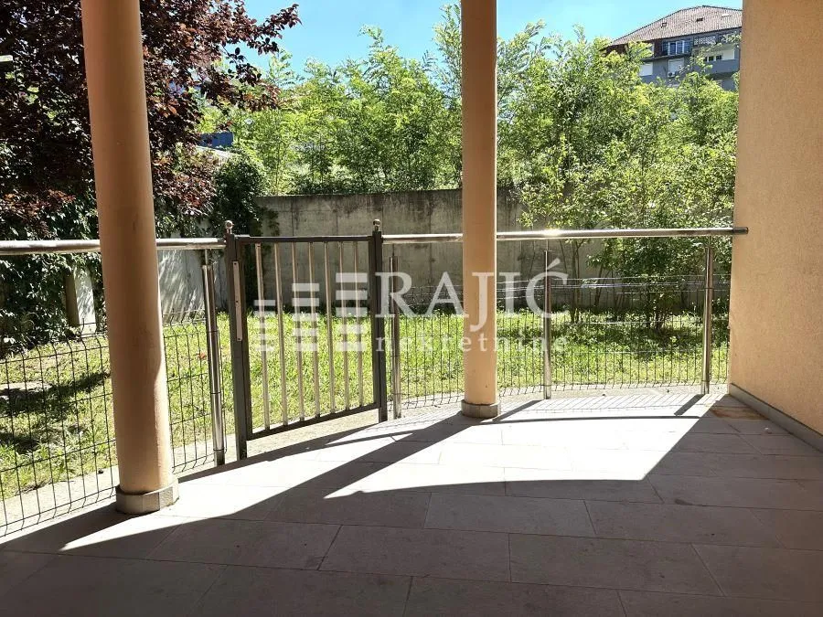 Covered terrace with a view of the yard and greenery.