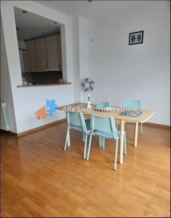 Dining area with a wooden table and chairs adjacent to the living space.