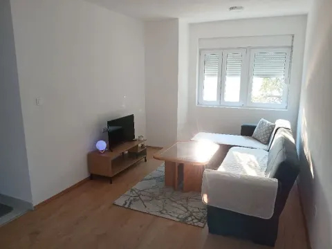 Bright living room with a sofa set and a television. - image 3