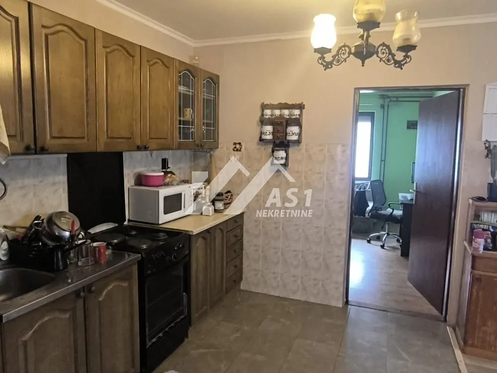 Kitchen with wooden cabinetry and a stove.