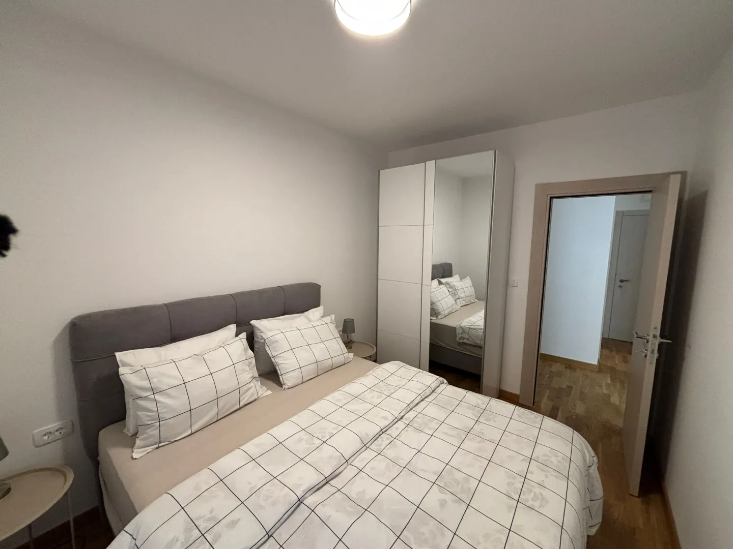 Furnished bedroom with a double bed and wardrobe.