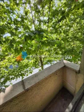 Small balcony with a view of trees and greenery. - image 11