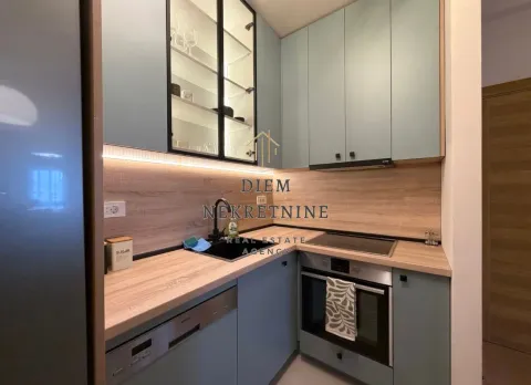 Modern and equipped kitchen with a countertop and built-in appliances. - image 8