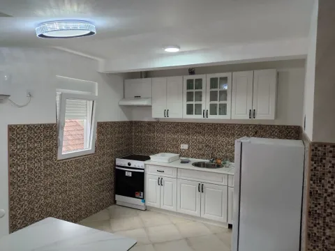 Bright and functional kitchen with white cabinets and mosaic tiles. - image 6