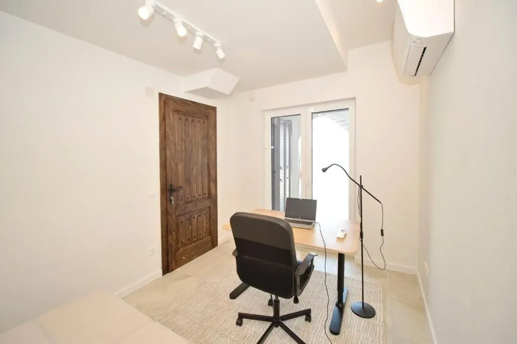 Study room with a desk, chair, and laptop.