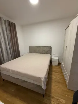 Furnished bedroom with a double bed, wardrobe, and nightstands. - image 5