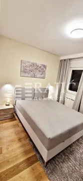 Furnished bedroom with a double bed and a nightstand. - image 6