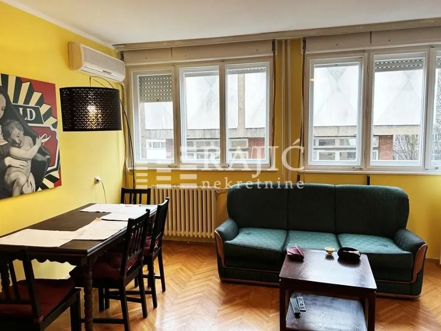Living room with a dining area and sofa set.