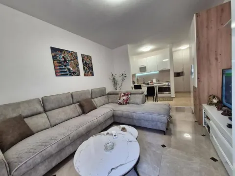 Living room with a sofa and a view towards the kitchen. - image 2