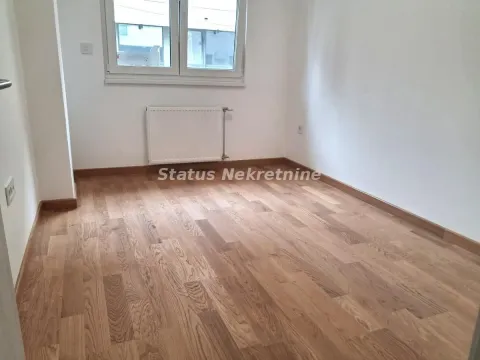 Empty room with hardwood flooring, white walls, and a radiator under the window. - image 9