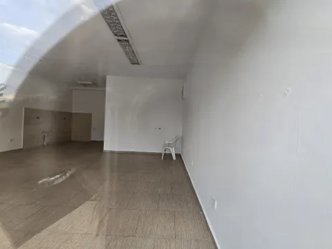 An empty interior space with tiled floors and white walls. - image 3