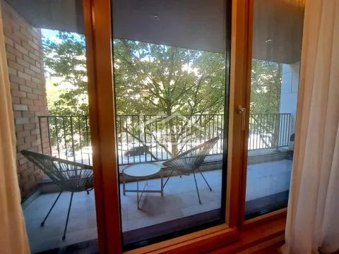 View of the covered terrace with seating furniture through the balcony door. - image 19