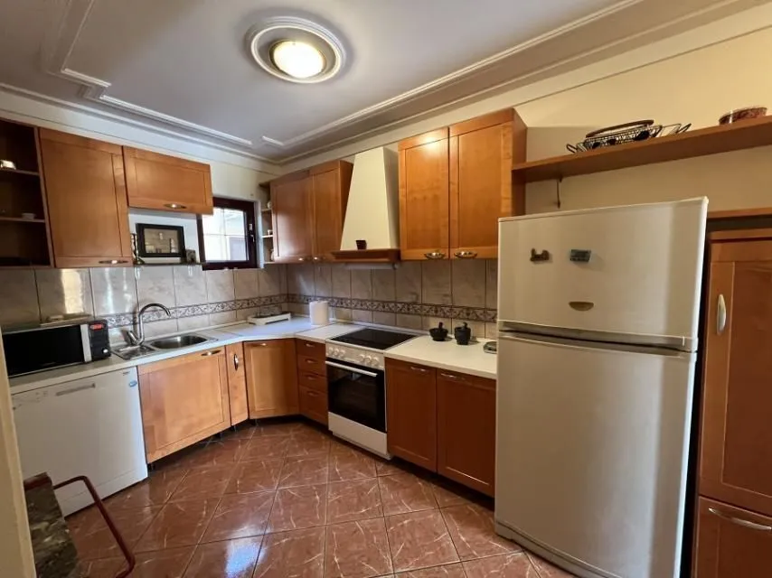 Kitchen with wooden cabinets and home appliances.