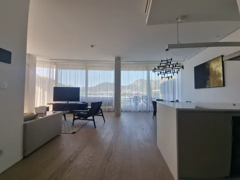 Spacious living room with large windows and a view of the surroundings. - image 10