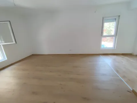 Empty room with laminate flooring and white walls. - image 4