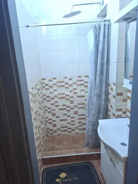 Smaller bathroom with a shower cabin and a sink. - image 4