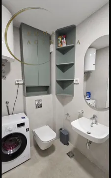 Modern equipped bathroom with a washbasin and washing machine. - image 7