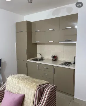 Small kitchen with beige cabinets and a sink. - image 3
