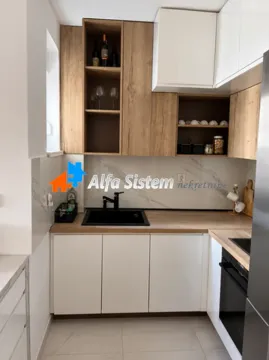 Modern kitchen with white cabinets and wood-grain details. - image 10