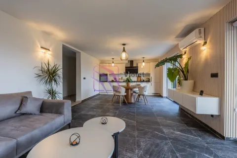 Spacious living room with a sofa set and a dining area in the background. - image 6