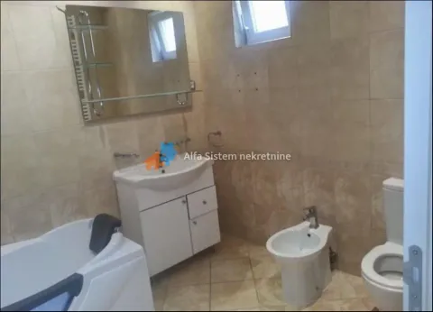 Tiled bathroom equipped with a bathtub, washbasin, and sanitary fixtures. - image 11