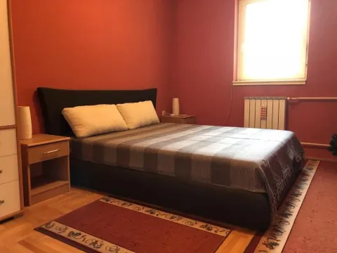 Bedroom with a double bed, red walls, and bedside tables. - image 5