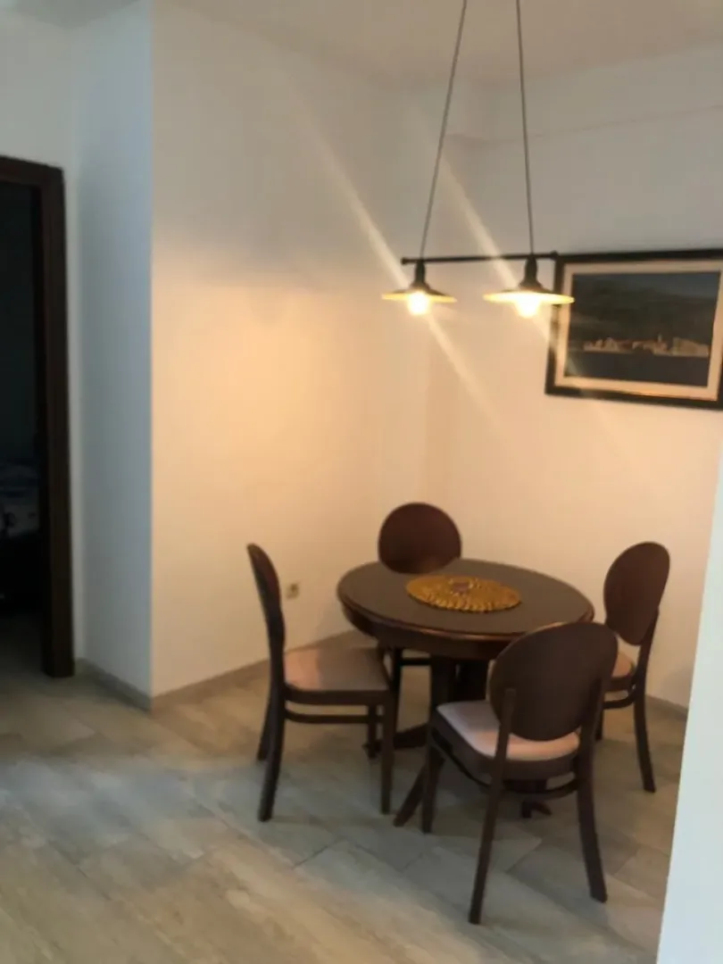Dining area with a table and four chairs.