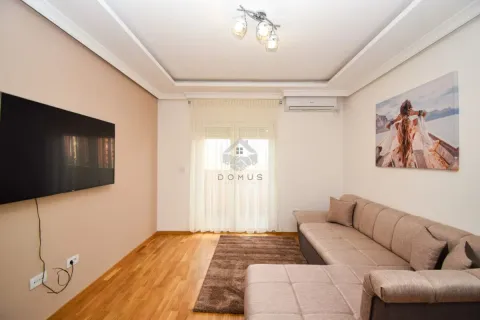 Living room with a sectional sofa, wall-mounted TV, and access to the terrace. - image 2